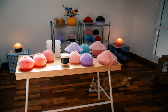 Colorful 3D printed lamp shades on display in creative studio