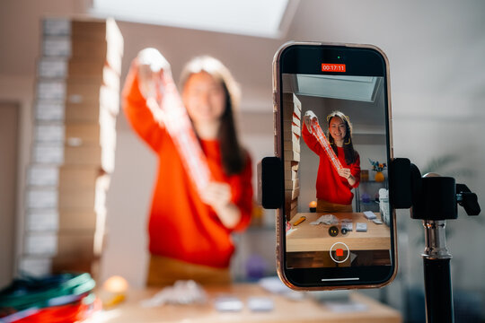 A person displays fragile tape in front of smartphone camera