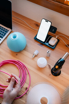 DIY lighting project with tools, parts, and bright pink cable