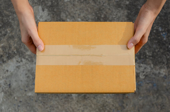 Woman holding a carton box