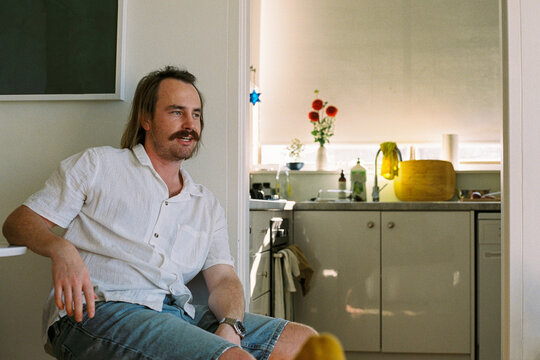 Casual Man in Modern Kitchen Relaxing