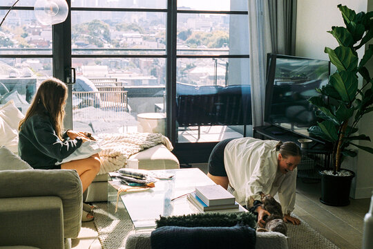 Cozy living room space with two women and dogs