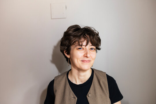 Portrait of Young Woman Smirking at Camera