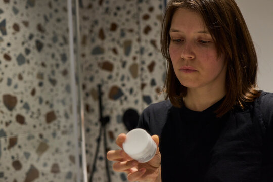 Woman reading skincare cream description