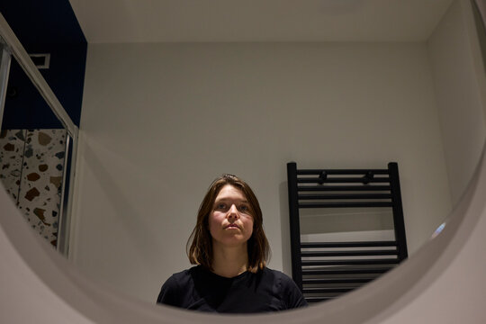 Woman photographing herself in a mirror