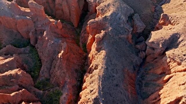 Full-frame aerial view of dramatic eroded sandstone canyon landscape in Kyrgyzstan during late afternoon sun