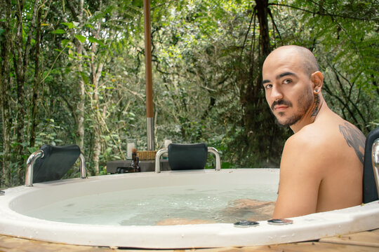 Man Relaxing in Outdoor Jacuzzi