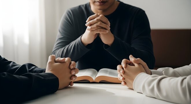 Man praying with people holding hands in a spiritual setting