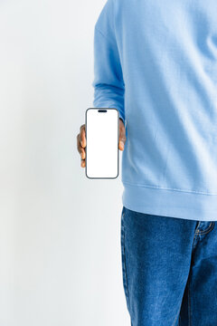 A mobile phone with white screen in man's hand