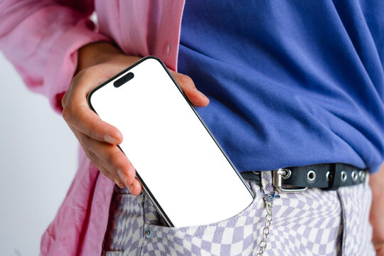 A mobile phone with white screen in woman's pocket