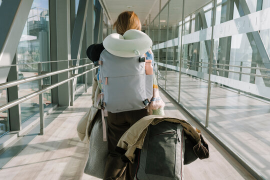 Woman walking with backpack and luggage
