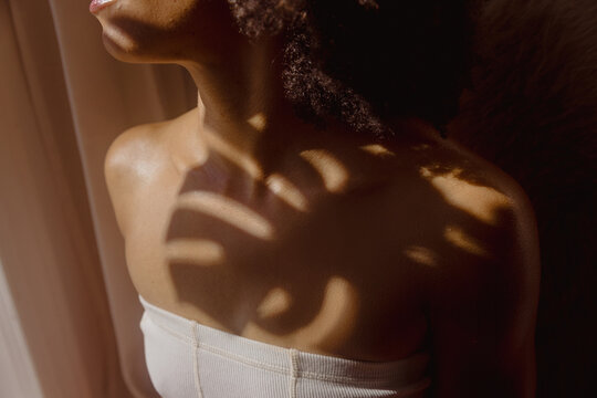 Woman with a botanical shadow on her skin