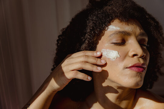 Beautiful woman using a face mask 