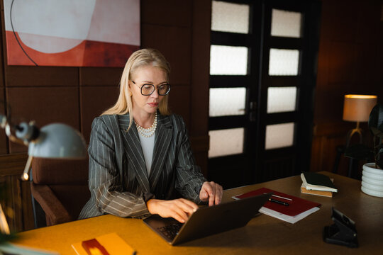 A woman uses a laptop in the office