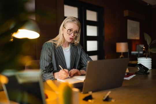 A woman is talking on a video chat in the office