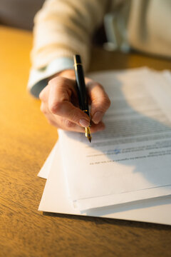 Woman's hands fill out the form