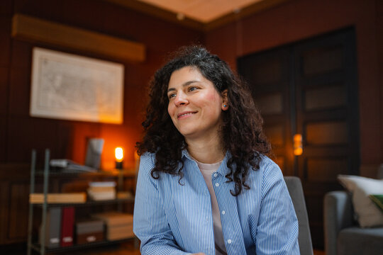 A woman is sitting in an armchair