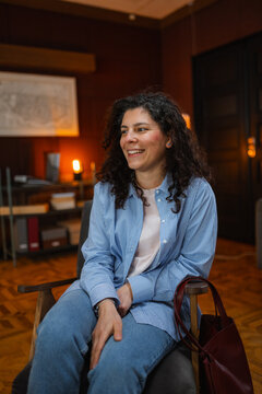 A woman is sitting in an armchair