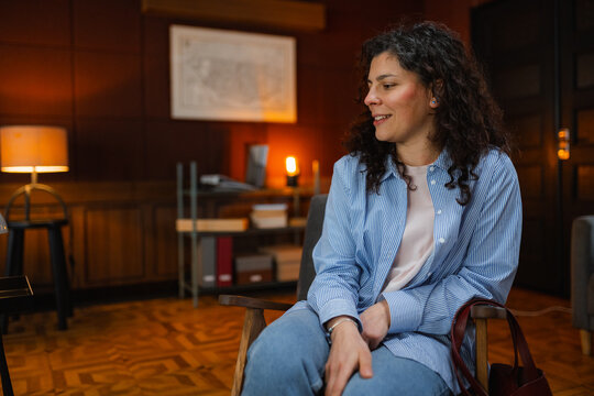 A woman is sitting in an armchair