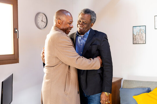 Two senior friends greeting each other in friends reunion