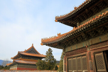 The blue glazed tiles on the wall as the background, the traditional architecture