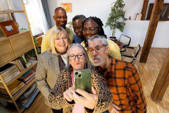 Diverse group of senior friends taking a selfie at home