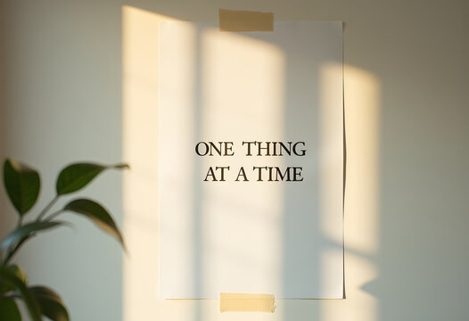 Motivational quote one thing at a time taped to wall