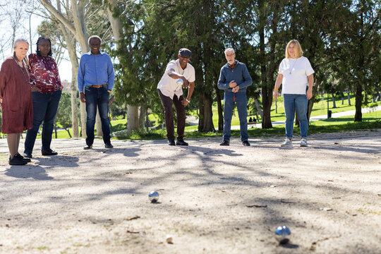 Diverse Group of Senior friends playing bocce in park
