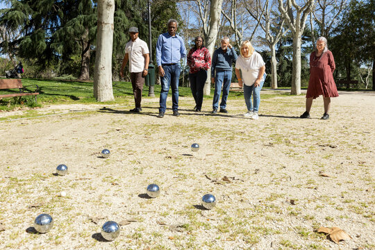 Diverse Group of Senior friends playing bocce in park