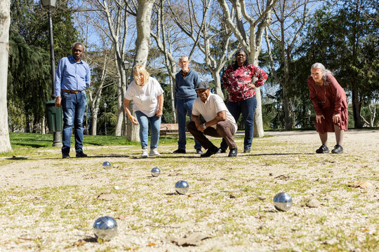 Diverse Group of Senior friends playing bocce in park