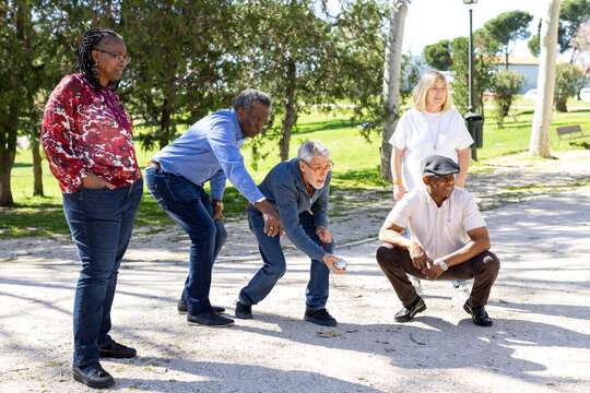 Diverse Group of Senior friends playing bocce in park