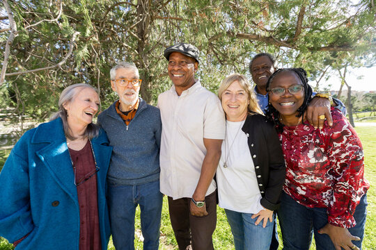 Group photo of diverse group of senior friends in park