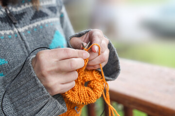 Close-up of hands knitting. Hands of a young woman knitting.