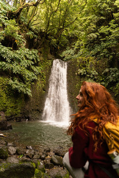 Woman backpacker waterfall hike