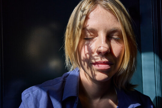 Woman soaking up window sun 