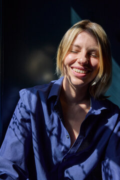 Woman soaking up window sun 