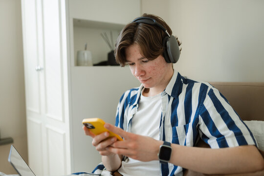 The man uses laptop at home