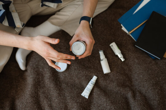 Man's hands with a bottle of cream