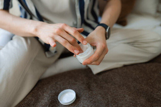 Man's hands with a bottle of cream