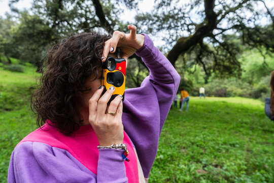 Woman using disposable camera