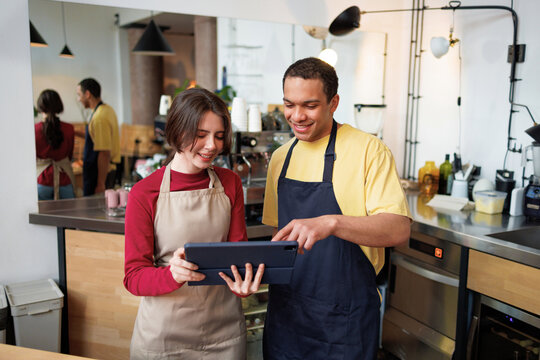 Coffee Shop Team Reviewing Tablet Together