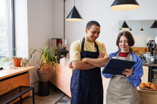 Coffee Shop Bakery Coworkers Using Tablet
