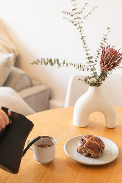 Tea serving with pastry and elegant floral decor