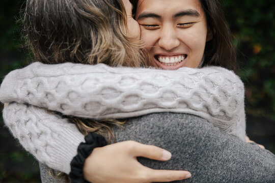 Reunion of Two Friends Sharing a Warm Embrace Outdoors