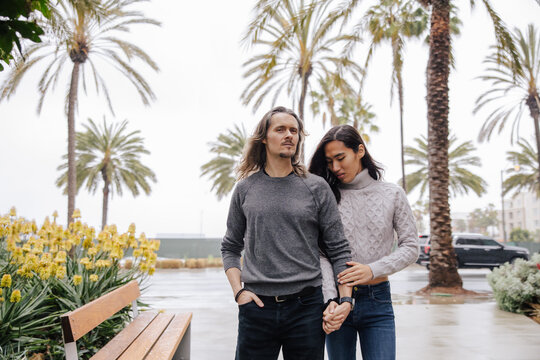 Couple in Outdoor Setting Surrounded by Palm Trees and Nature