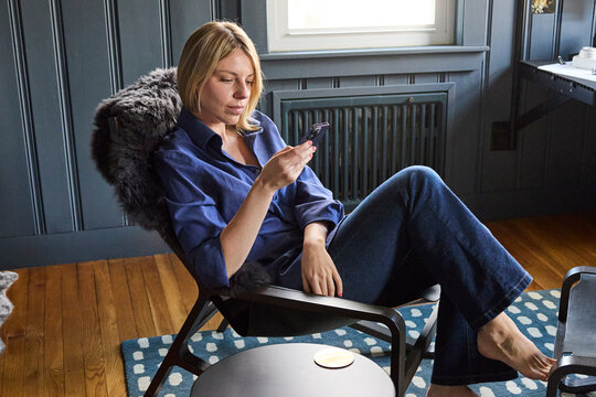 Young woman lounges in her chair at home 