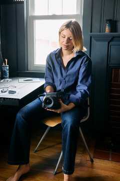 Young woman photographer at her desk 