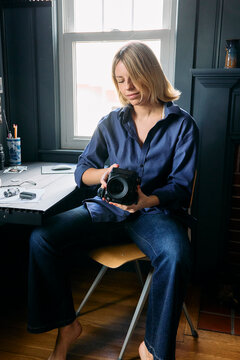 Young woman photographer at her desk 