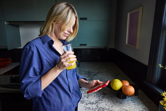 Woman drinking magnesium mix in the kitchen