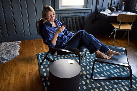 Young woman lounges in her chair at home 